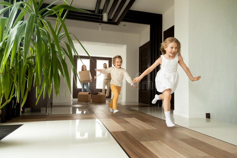 excited-children-running-house-moving-day-new-home-happy-young-family-cardboard-boxes-concept-big-modern-own-103731249